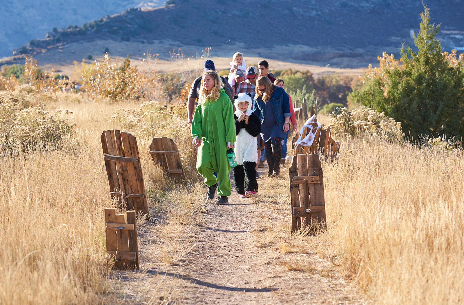 People walk along a trail.