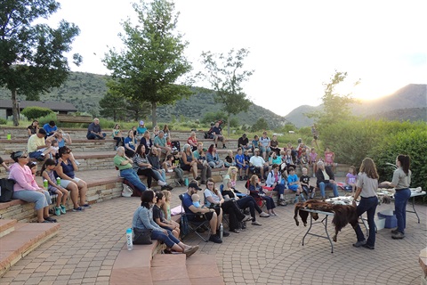 A campfire program crowd watches a park ranger presentation.