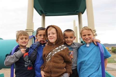 A group of children pose at a city park.