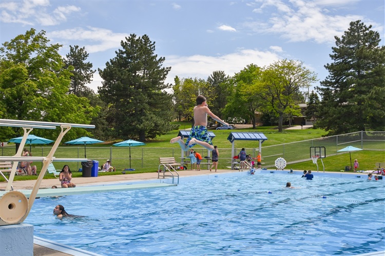 A child jumps off of the diving board at Glennon Heights pool.