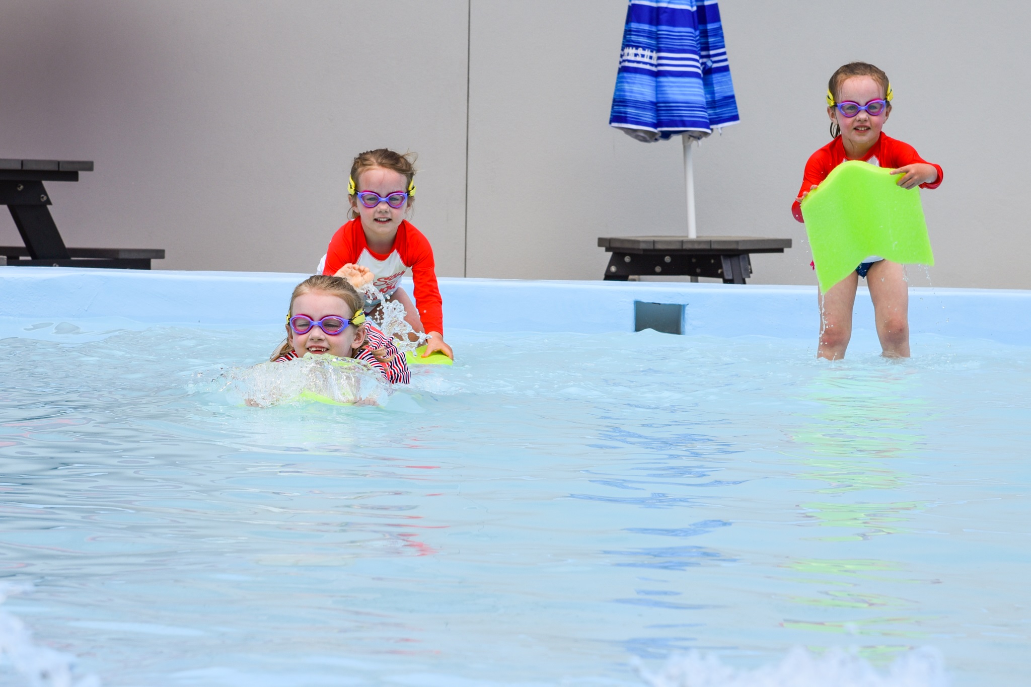 Three children in the baby pool. 