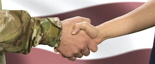 Vet in uniform shakes hands