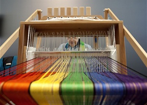 Rainbow colored wool spinning at Earth Day