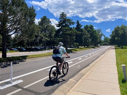 Man riding down the street in a bike lane