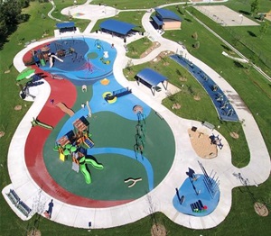 Aerial view of colorful play areas and winding paths at Carmody Park playground