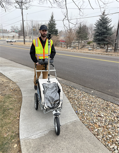 Man in yellow vest pushing a pathMet device