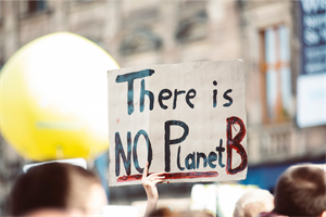 Person holding up sign that says There is No Planet B