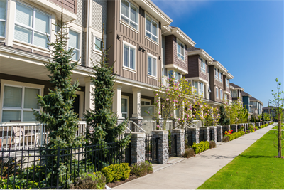 row of townhomes with green grass in front