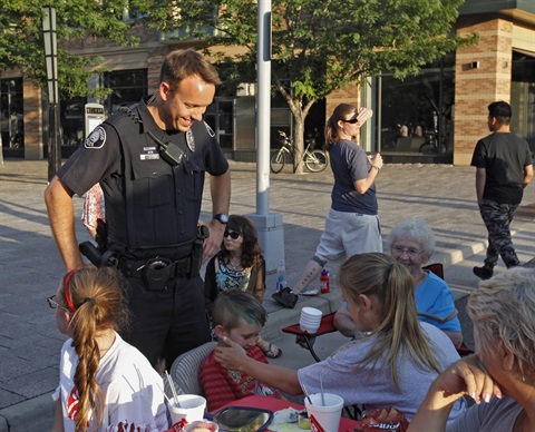 A Police officer speaking to citizens.