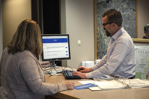 Lakewood Planner working at the Planner of the Day counter.