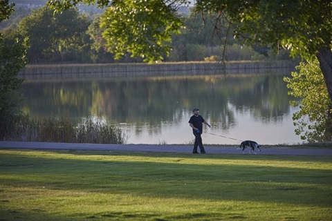 A man walking a dog in kendrick-park